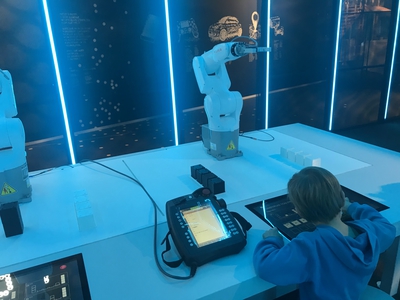 Enfant qui teste le robot lors de l'exposition La Fabrique au Vaisseau de Strasbourg